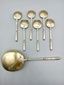 Russian-style silver and vermeil ice service with ornate spoons.