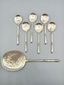 Russian-style silver and vermeil ice service with ornate spoons.