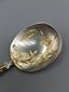 Russian-style silver and vermeil ice service with ornate spoons.